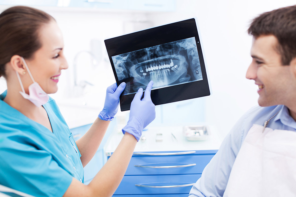 Dentist explaining dental concerns with patient
